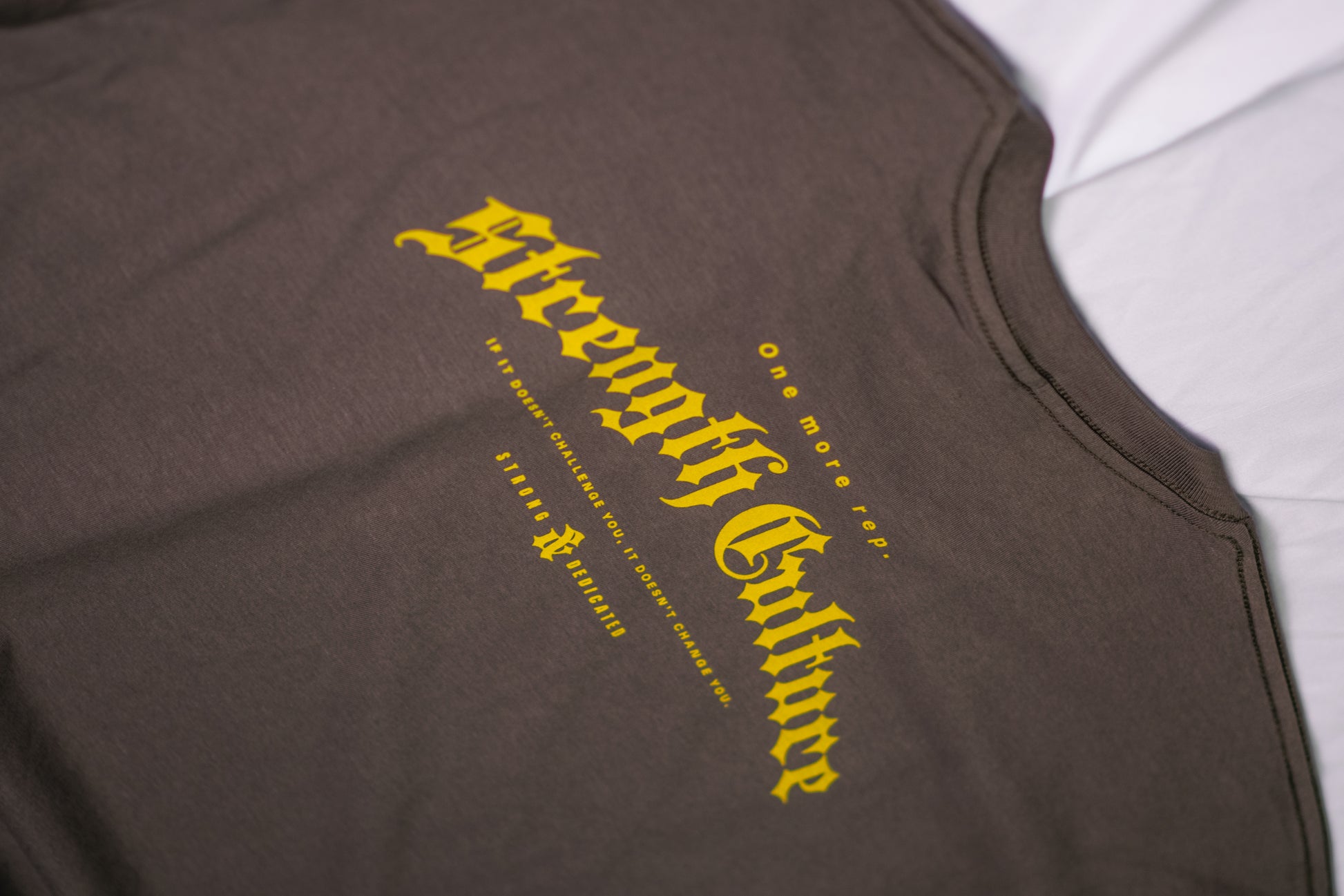 Brown tank top with yellow text on a white background